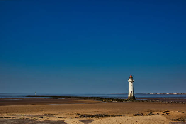 White lighthouse in stormy sea at Rattray Head, Aberdeenshire, Scotland