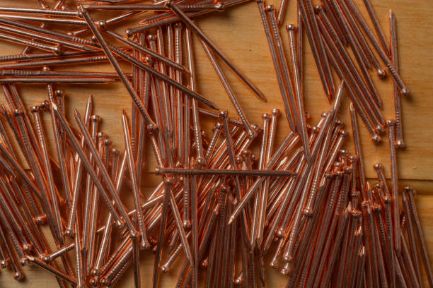 istock copper nails on wooden background 2173156224