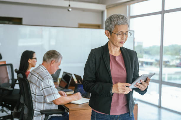 istock Leadership in Action: Senior Asian Female Leader with Her Colleagues 2173157183