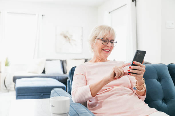istock Senior woman using smartphone at home during breakfast 2173158334