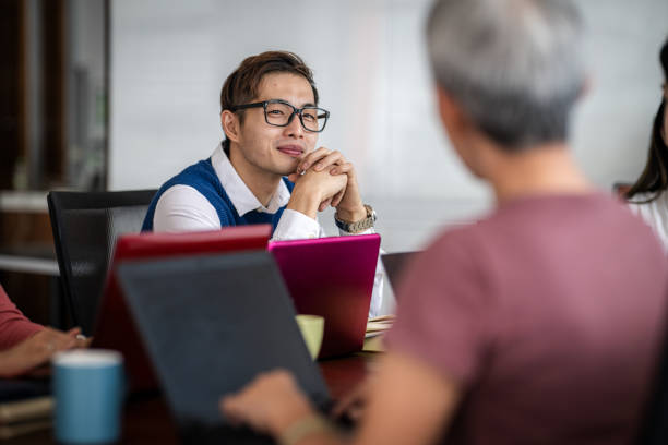 istock Dynamic Exchange: Colleagues Collaborating in a Modern Meeting 2173159522