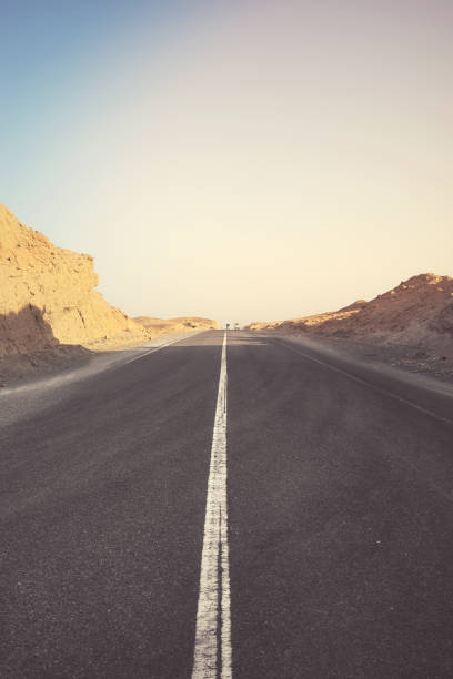 istock Desert road at sunset, color toning applied, Egypt. 2173167620