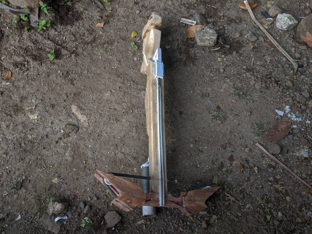 A handcrafted wooden crossbow with a visible string and trigger mechanism