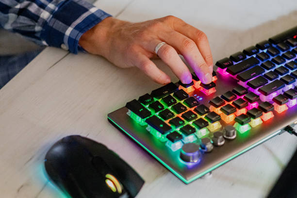 istock Close-up of man's hands while playing computer games with rgb computer keyboard and mouse. 2173174591
