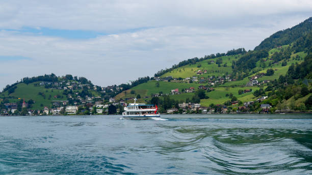 Alpine mountains and lake Lucerne on sunset, Switzerland. Reflection of sunset rays on the water surface. Natural landscape in the Switzerland in summer. Summer vacation