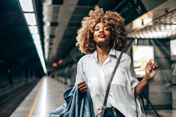 istock Beautiful Afro woman standing at subway station platform 2173178948