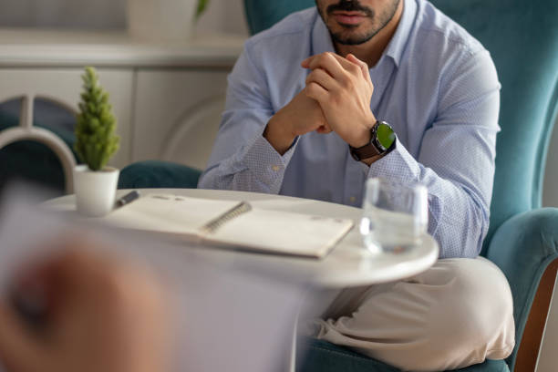 istock The psychologist listens to his patient with problems at home and takes notes in his notebook 2173179809
