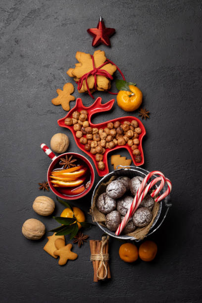 istock Christmas tree-shaped with cookies, surrounded by assorted nuts and festive decor 2173182939