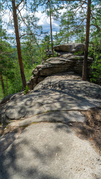 istock Small Devils rock, Devil's Hillfort complex on sunny summer day. Iset Park, Iset village, Sverdlovsk region, Russia. Hiking. Pine trees on rock. Vertical image 2173182964
