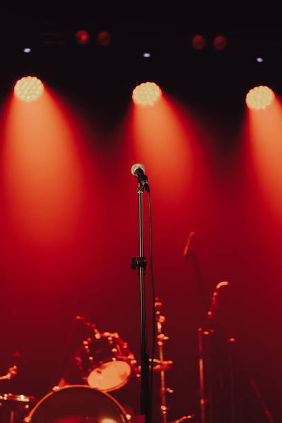 istock Background - microphone on stage against red spotlights, no people 2173183031
