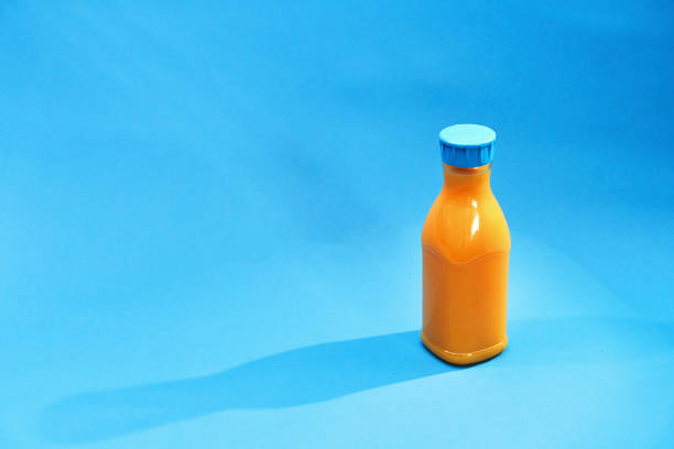 Orange Juice in Recycled PET Plastic Bottle on Blue Background