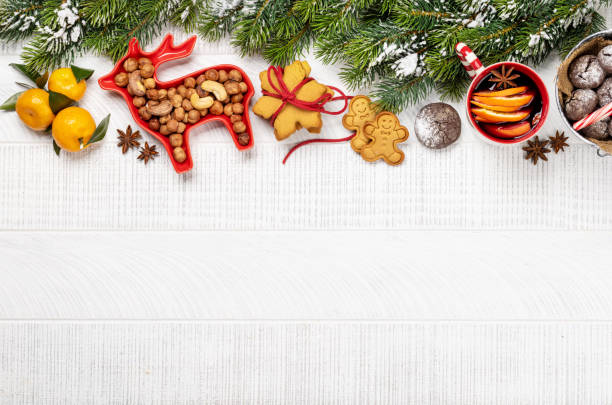 istock Christmas background with fir tree, gingerbread cookies, nuts, and copy space for greetings 2173183579