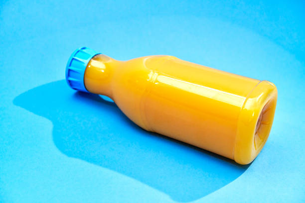 Orange Juice in Recycled PET Plastic Bottle on Blue Background