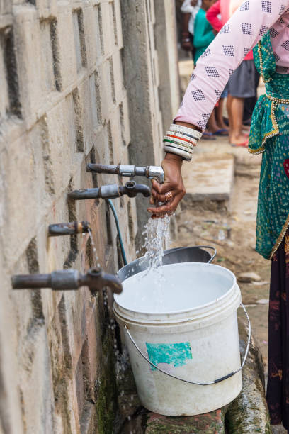 istock Filling a bucket with drinking water at a public tap. 2173189326