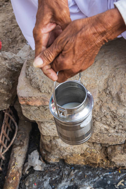 istock Man holding small metal milk can. 2173189352