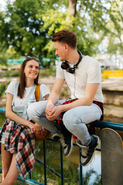 istock Two fiends talking and hanging out in the park 2173190550