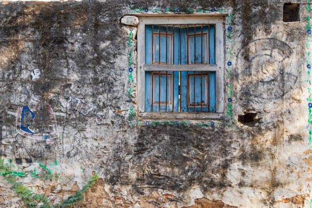 A close-up of an old, abandoned house.