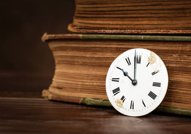 istock Old clock face and books, daylight savings time 2173193431