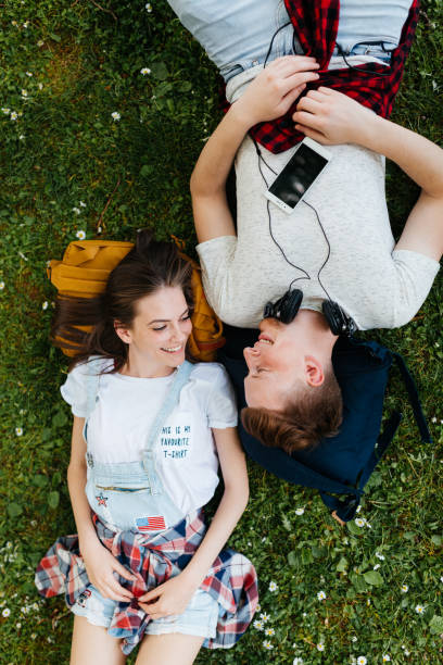 istock Young people lying on the grass and hanging out 2173197333