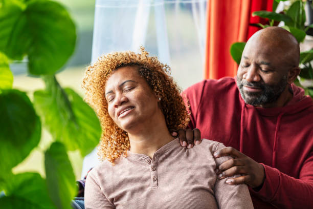 istock Mature man massaging wife's shoulder, at home 2173201535
