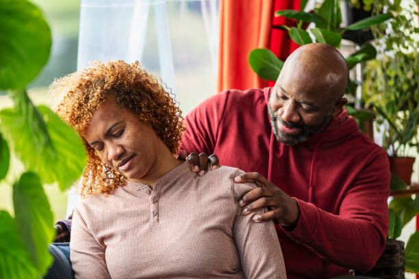 istock Mature man massaging wife's shoulder, at home 2173201538