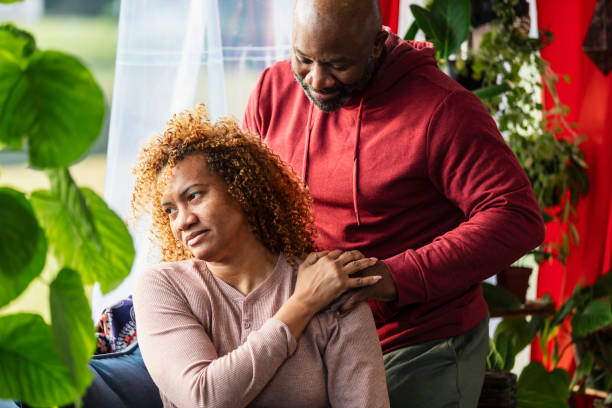 istock Mature man massaging wife's shoulder, at home 2173201546