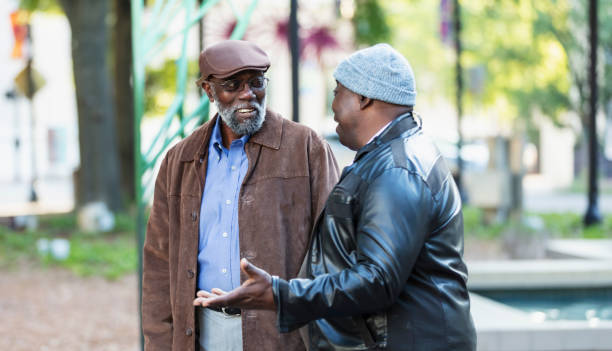 istock Two senior African-American men talking in city park 2173201918