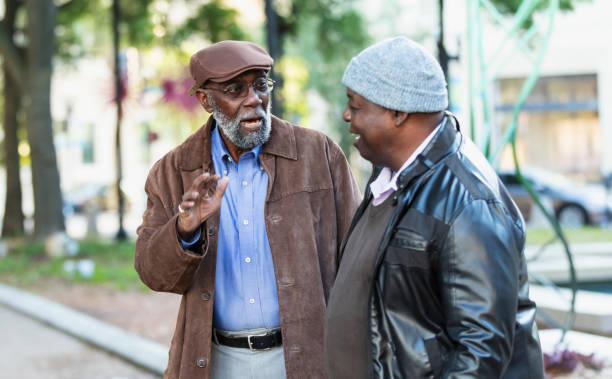 istock Two senior African-American men talking in city park 2173201919