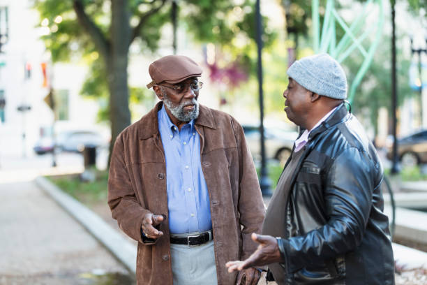 istock Two senior African-American men talking in city park 2173201920