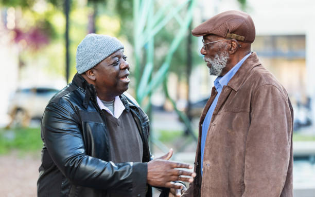 istock Two senior African-American men talking in city park 2173201928