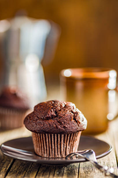 istock Sweet chocolate muffin cakes on plate on wooden table. 2173202109