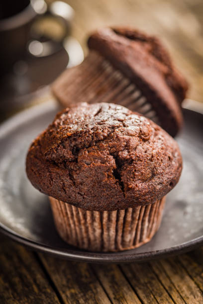 istock Sweet chocolate muffin cakes on plate on wooden table. 2173202349