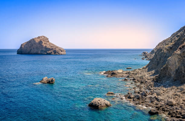 Scenic seascape in Amorgos Island. Picture taken from the beach of Agia Anna, a small rocky beach famous for the scenes in the movie “The Big Blue”. In Cyclades, Greece.