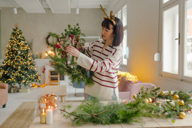 istock Young woman making a Christmas wreath 2173206127
