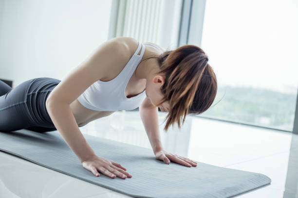 istock A woman is holding a plank on a mat. 2173214820