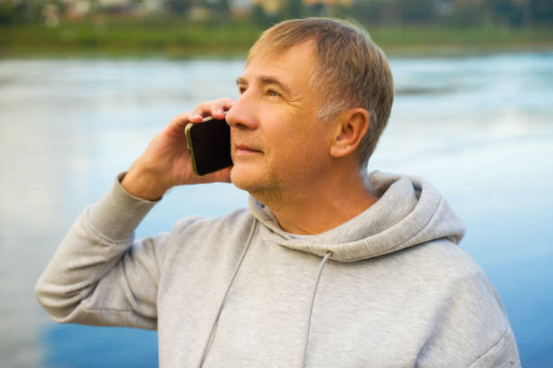 istock Man having phone call at the beach on a autumn day 2173226502