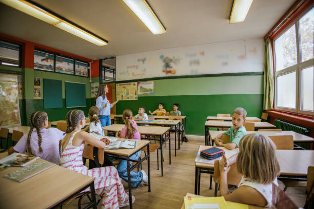 istock Teacher conducts a classroom lesson with attentive students in a bright educational environment 2173227313