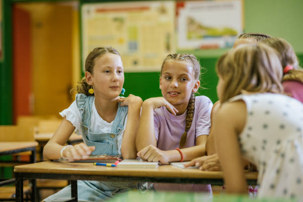 istock Students enjoy a lively conversation during a break in the classroom at school, fostering friendships and collaboration 2173227517