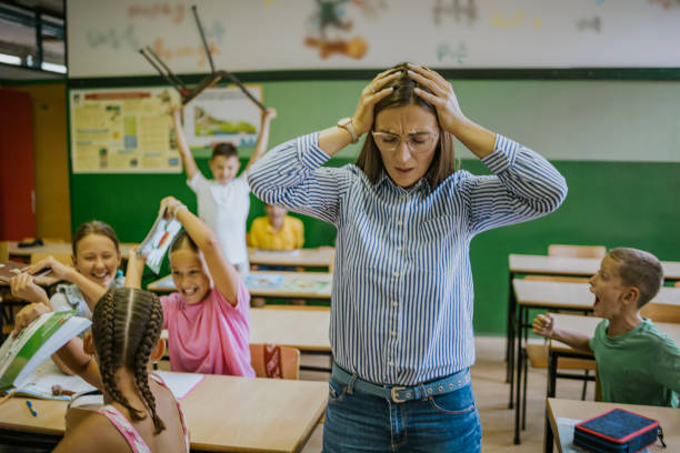 istock Students create chaos in classroom during lesson at local school, resulting in teacher's overwhelmed reaction 2173227722