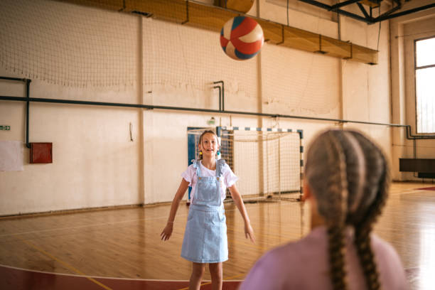 istock Students engage in volleyball practice in the school gym during physical education class 2173227794
