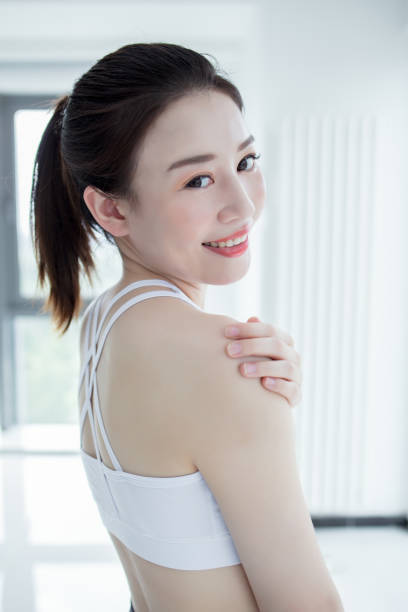 istock athletic woman holding her shoulder as if experiencing pain. 2173234832