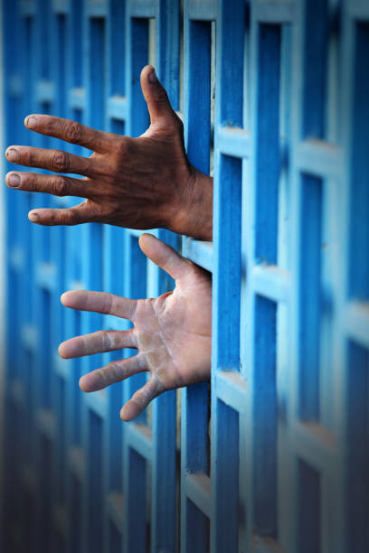 istock Hands Reaching Through a Wooden Blue Screen 2173237753