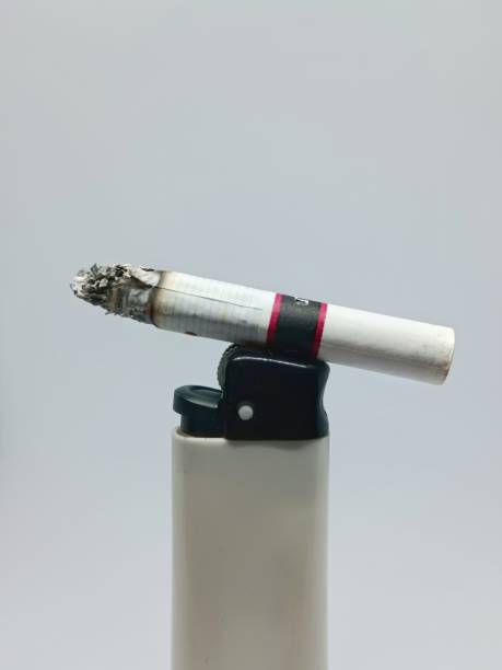 istock Close-Up shot of cigarette burning on a lighter on a isolated white background. 2173238361