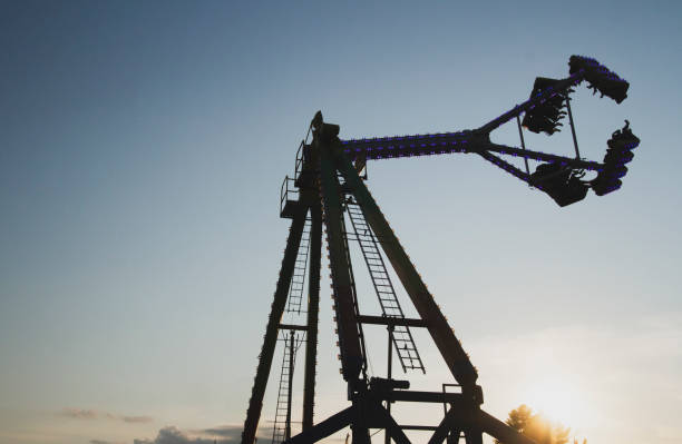 istock Silhouette of an amusement ride at a fair against the setting sun. 2173246899