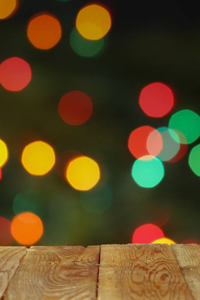 istock Empty wooden table in front of blurred christmas lights background 2173247078