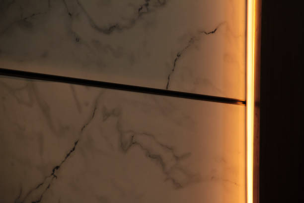 Home Interior - marble wall with led lights in warm orange color