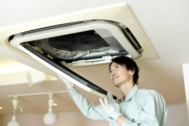istock Asian male worker checking a ceiling-mounted air conditioner 2173254677