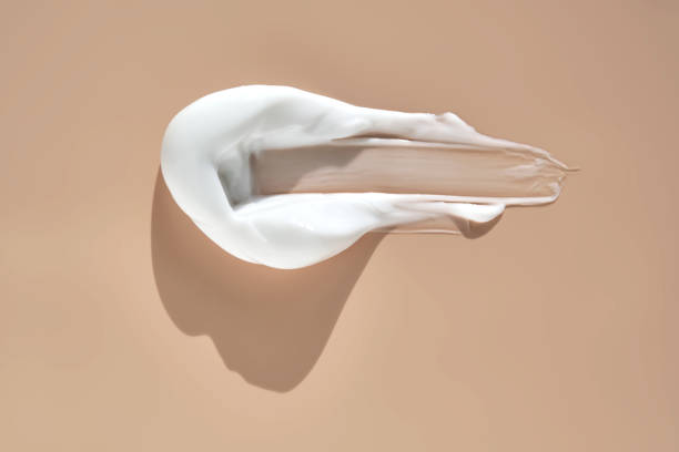 istock A smear of white cream on a beige background. 2173257157