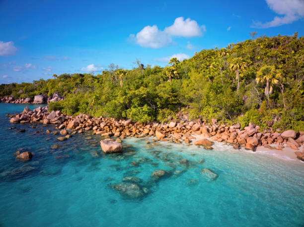 Seychelles Praslin Island Aerial Drone view over Anse Lazio Beach at Baie Chevalier Coast with typical Seychellois Granite Rock formations in between white sandy dream beaches. Natural coral lagoon and beaches on the Baie Chevalier of Praslin Island, Seychelles Islands, East Africa