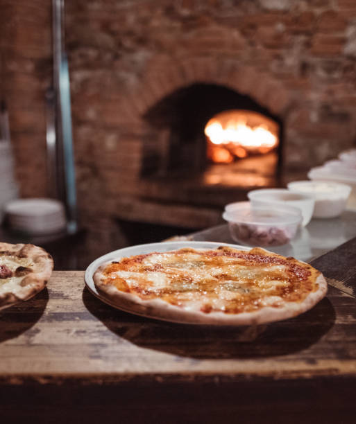 pizza in front of the wood oven